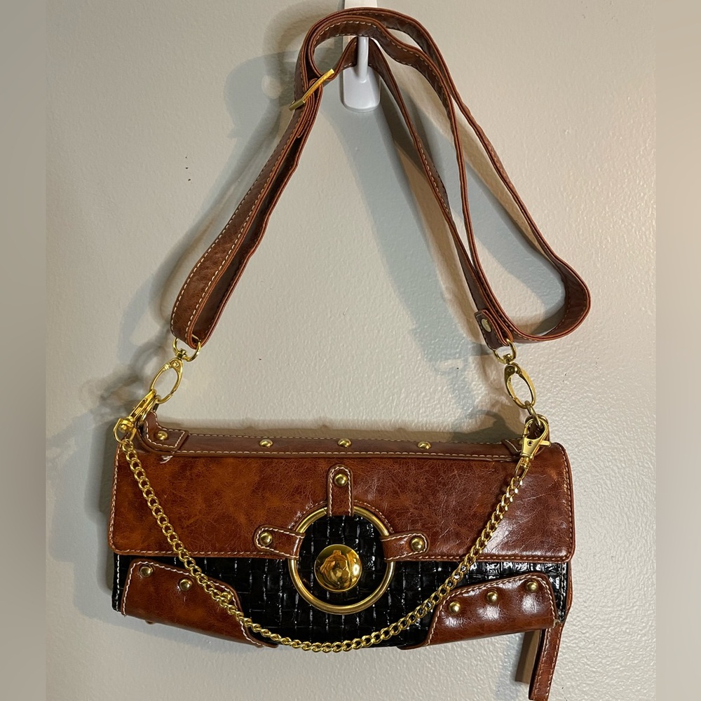 Black and brown shoulder bag/purse with gold color chain and accents.